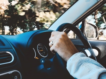 Hand on steering wheel